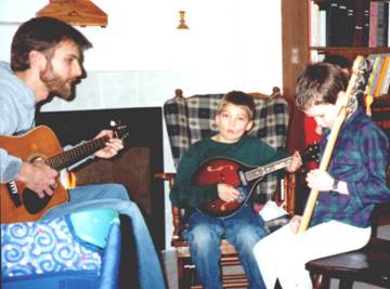 Nate on Guitar with Josh (Mandolin) and Beni (Bass). Photo by Paula Wilson